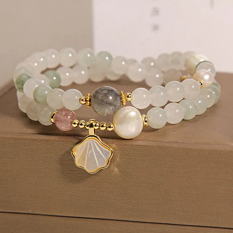 Women's crystal bracelet with Tianshan Jade ginkgo leaf pendant and gold-plated inlay.