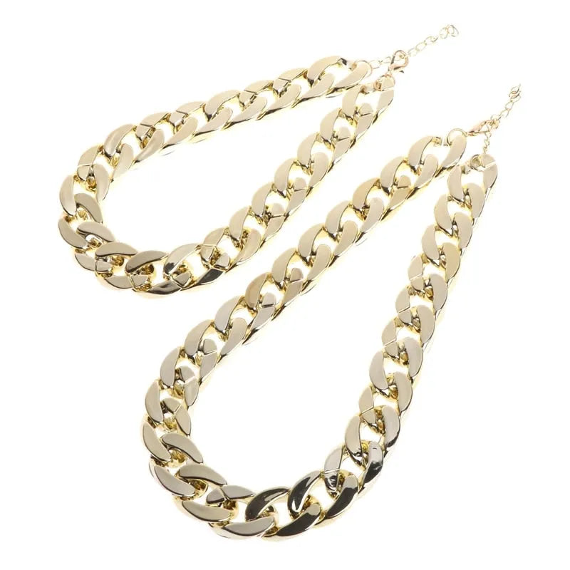 Gold plated plastic pet necklace with thick chain design on a small dog