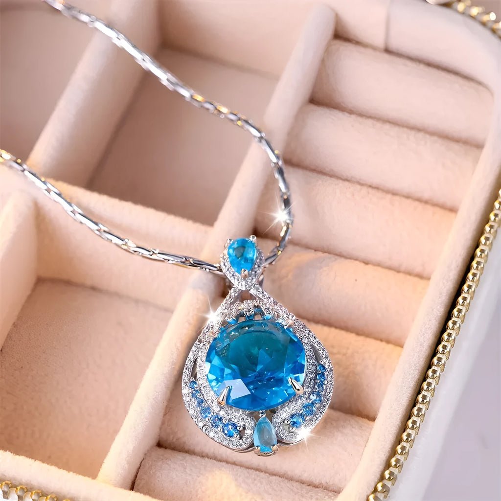 Women's geometric necklace with fireworks-cut blue gem pendant on water wave chain
