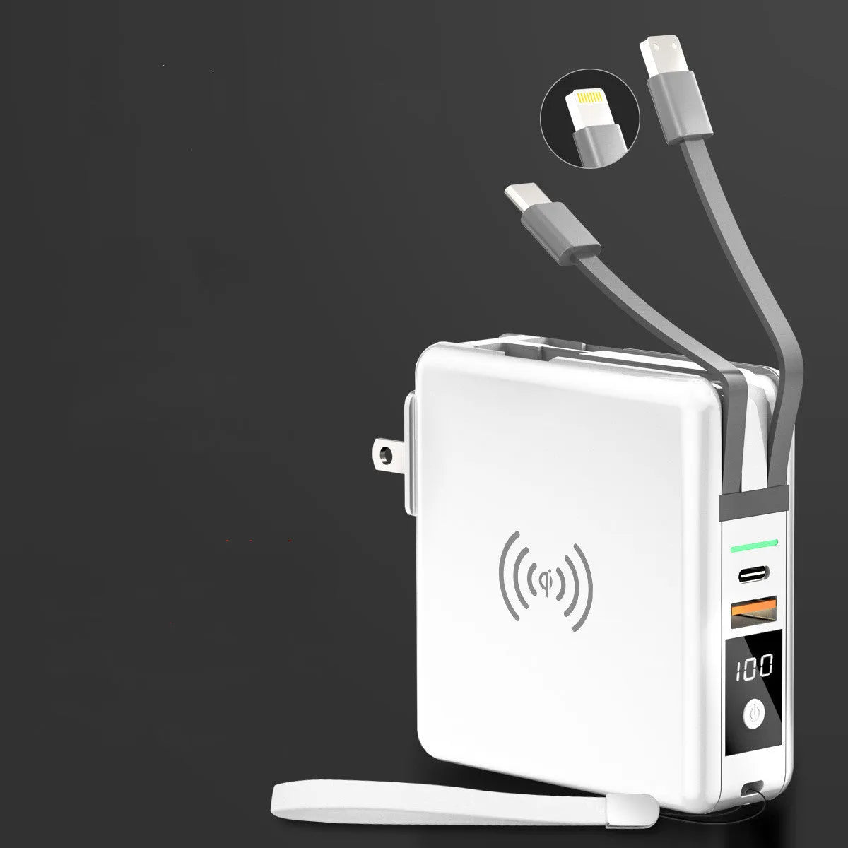 Black Super QI wireless power bank with integrated folding plug shown on a table next to a smartphone.