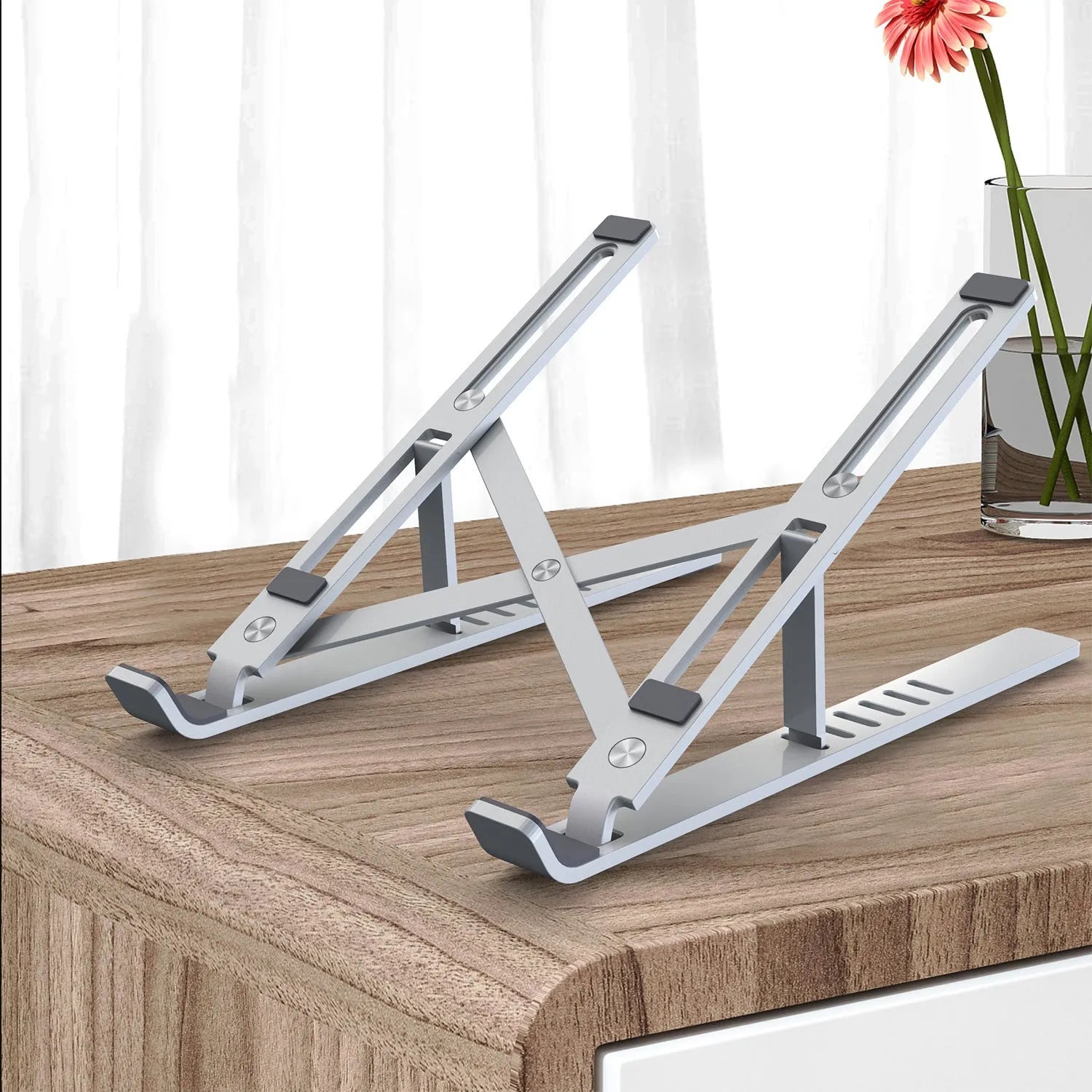 Aluminium laptop stand shown in silver colour with six height adjustment positions visible