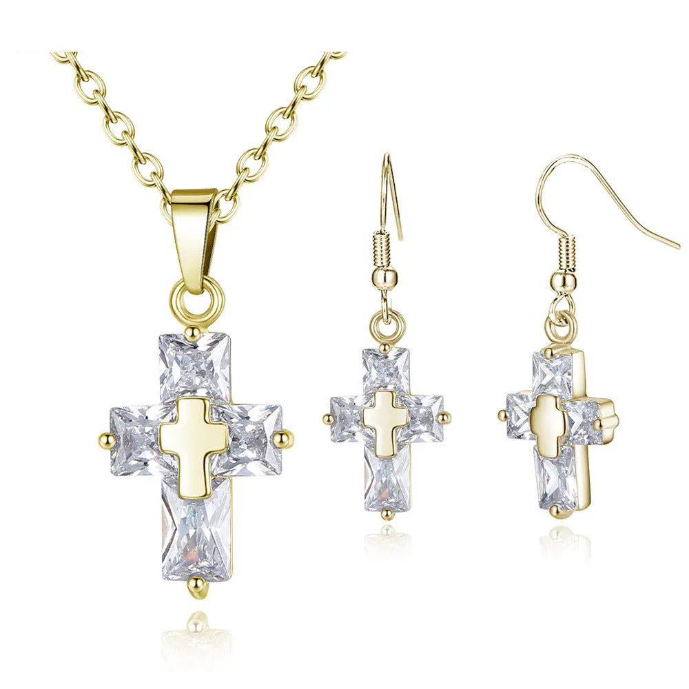 Gold cross pendant and matching stud earrings set on a light background showing compact 1.2 x 2.2 cm pendant and 3.3 x 1.2 cm studs