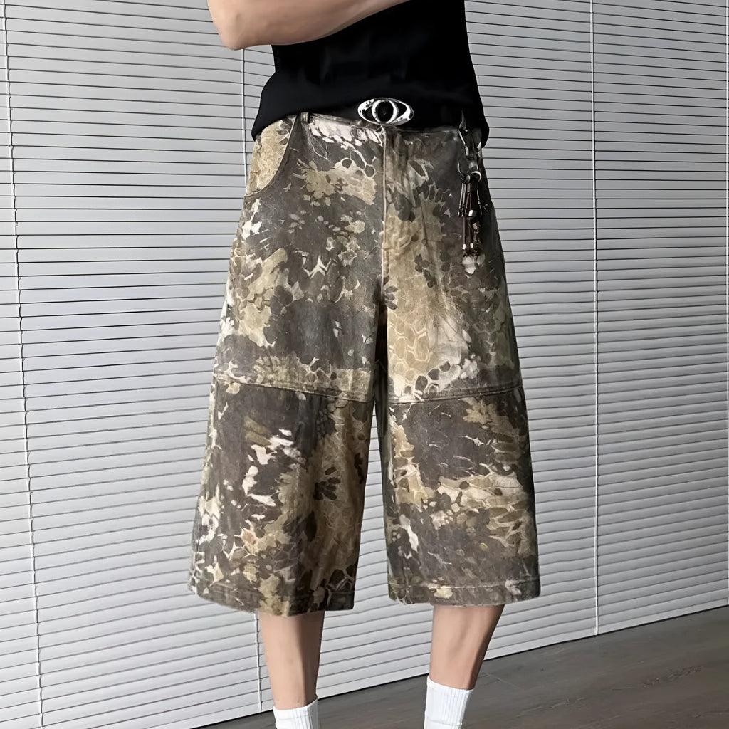 Yellow denim jeans with a snake camouflage pattern and cropped leg hem.