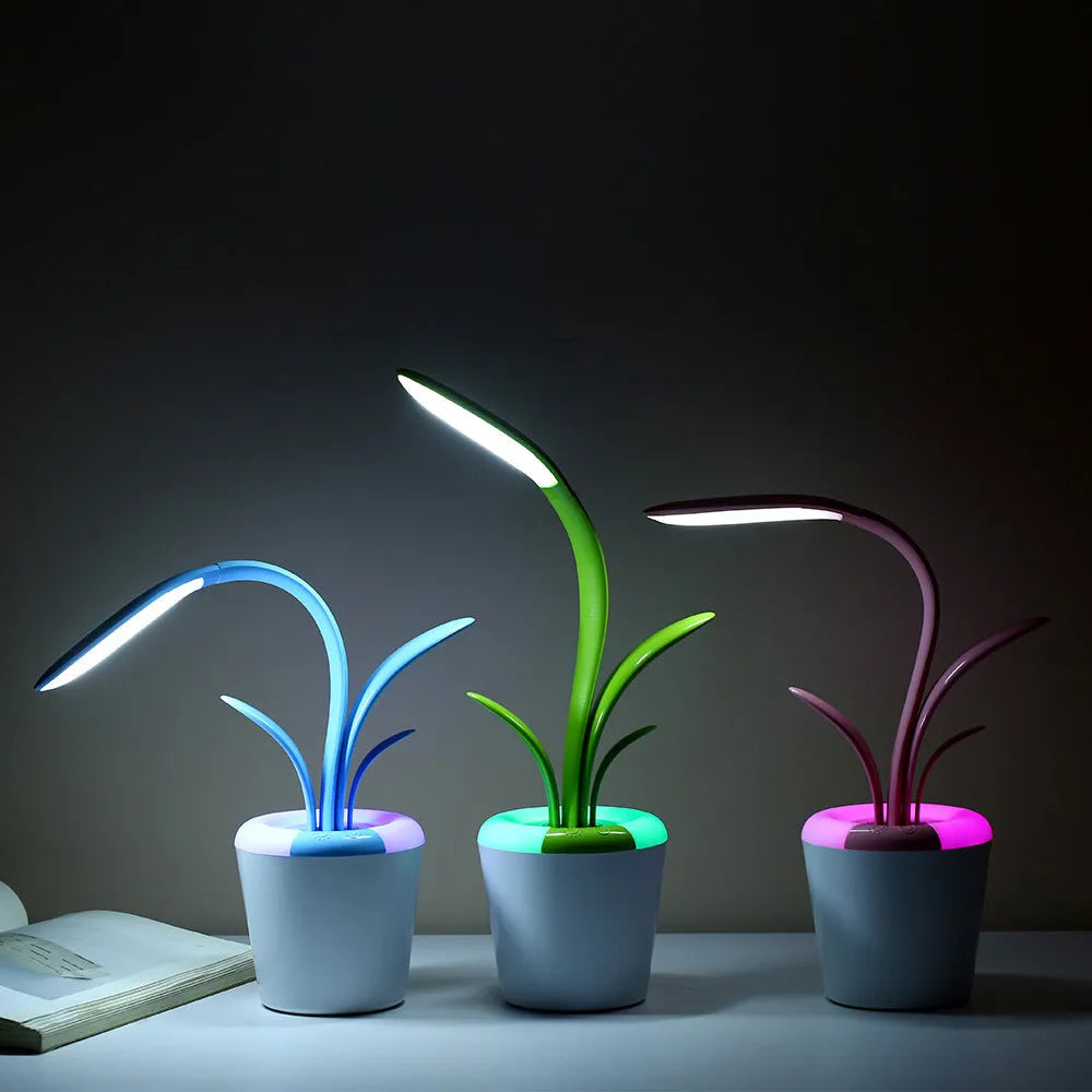 Modern rechargeable desk lamp with plant shape design in pink, showing touch control on a wooden end table