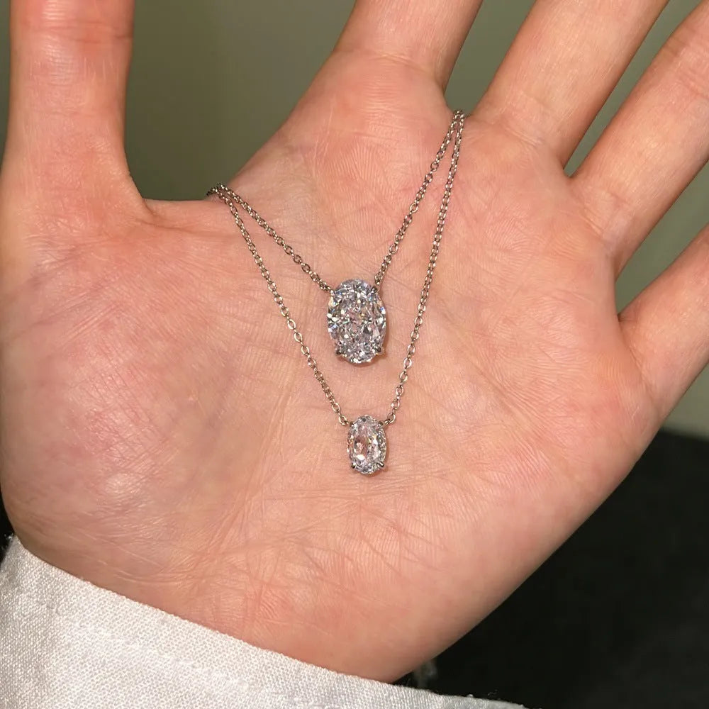 A sterling silver necklace with a geometric oval ice flower pendant on a chain.