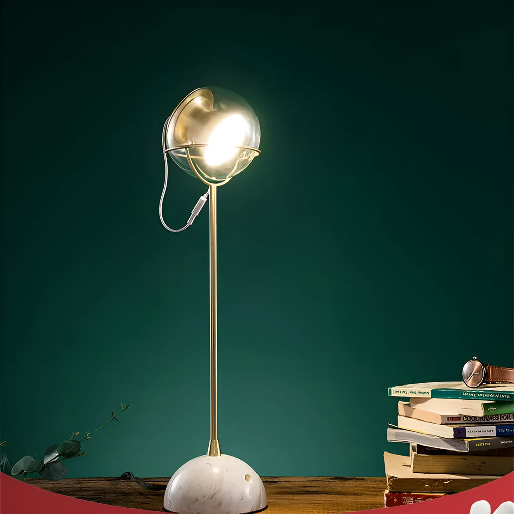 Dimmable touch-controlled desk lamp with glass shade on wooden desk