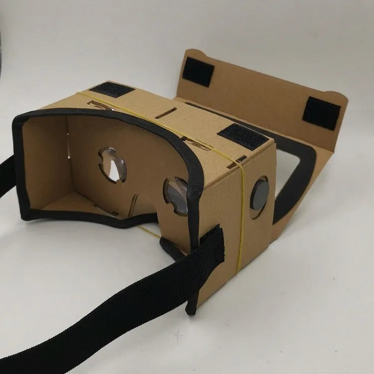 Pink and white cardboard VR glasses with 3D lenses and a rubber head strap for smartphones.