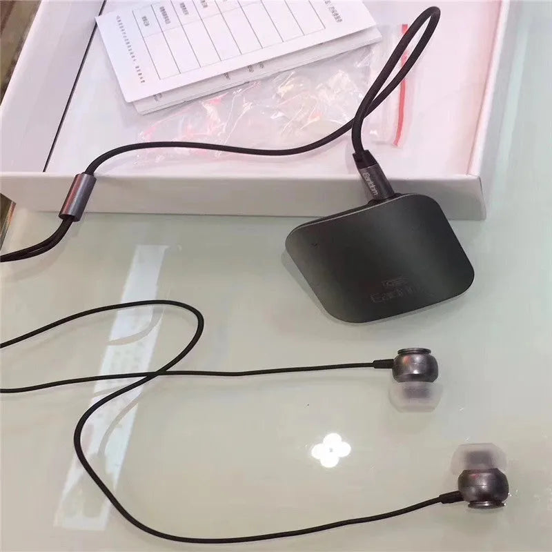 Black Bluetooth lavalier headset with microphone, showing wireless audio receiver unit.