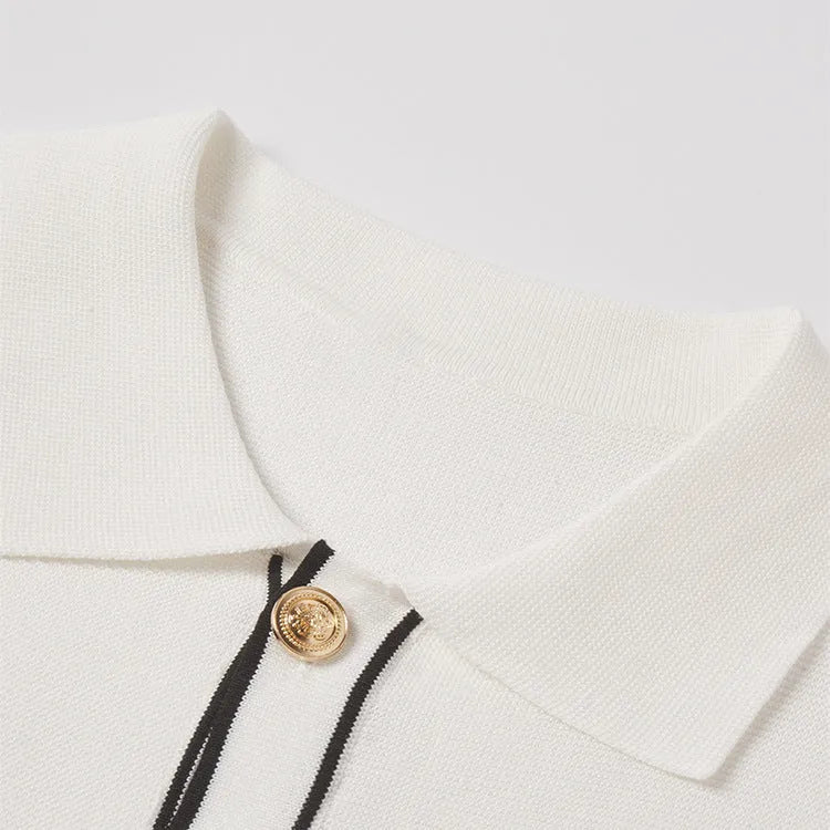 White short-sleeve cardigan with dark contrast lapels, shown on a model, old money style.
