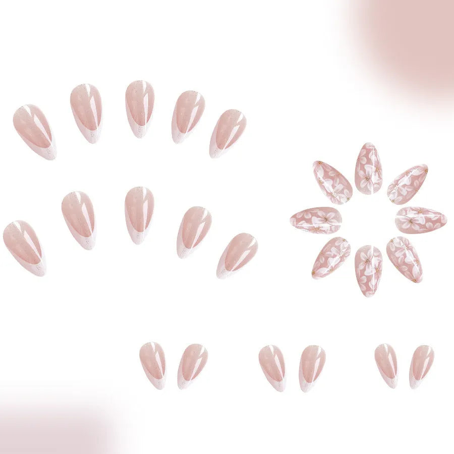 Short almond shaped false nails with glossy finish, glitter, and powder flower design in C625 colour.