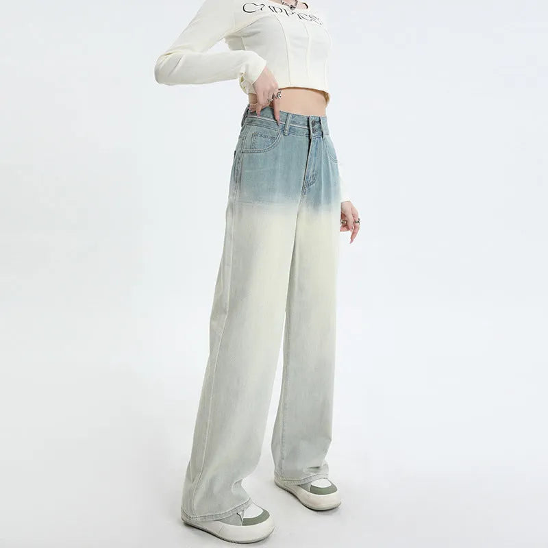 Women's gradient blue straight-leg denim trousers on a hanger, showing wide-leg silhouette.