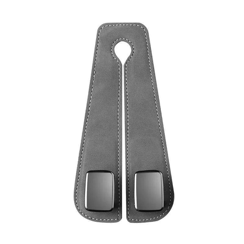 Black alloy car seat hook with suede covering attached to a grey car seatback.