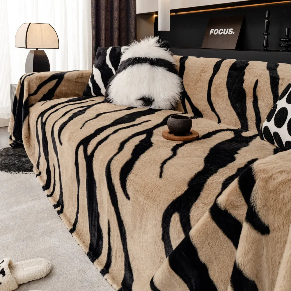 Zebra pattern flannel sofa cover in caramel colour on a sofa, showing non-slip fit and matching pillowcase.