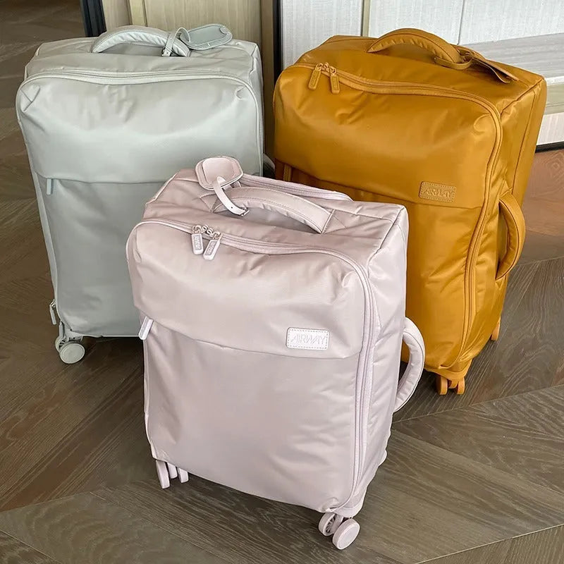 Ultra-light waterproof Oxford cloth suitcase in bluestone green with universal wheels.