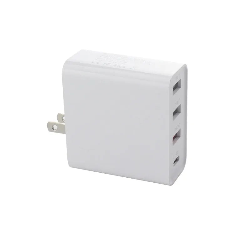 Black 48W USB-C four-port fast wall charger with UK plug on a wooden surface