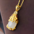 Hetian jade antique gold pendant necklace with cartoon pi xiu design and cross chain.