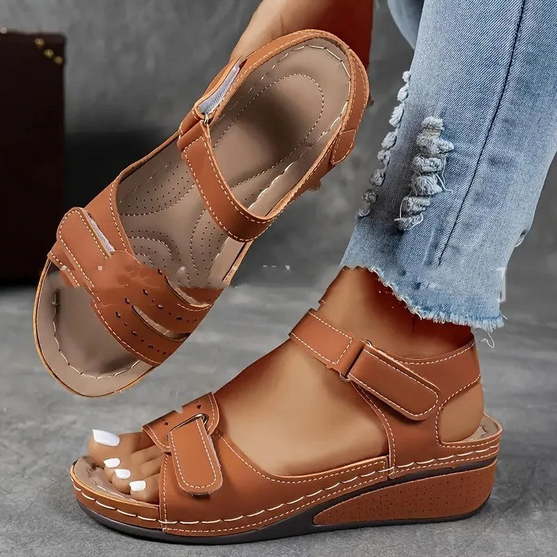 Women's beige thick-bottom strap sandals showing the Velcro fastener and round toe design.