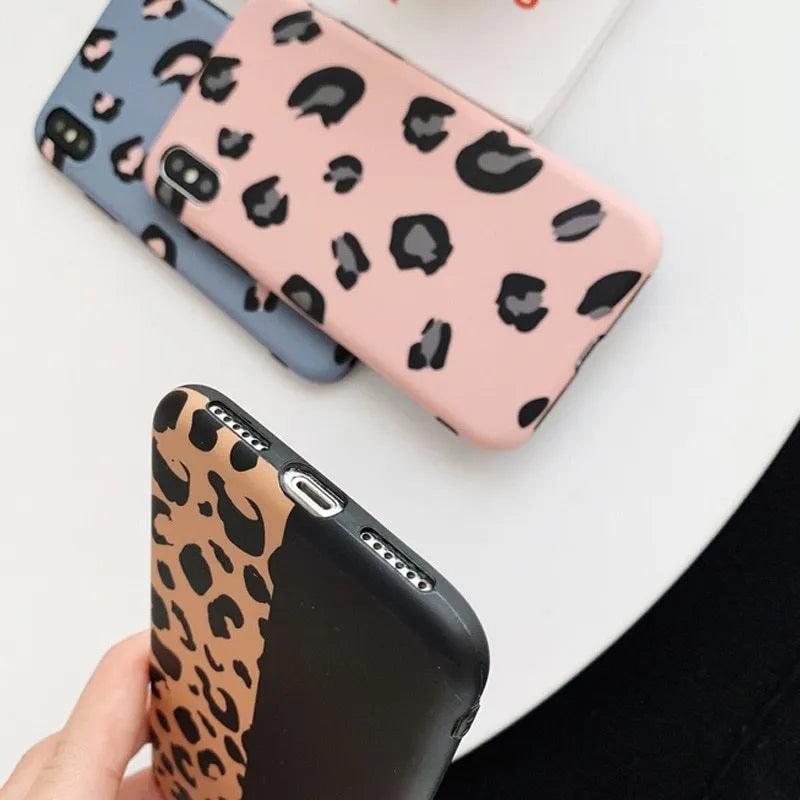 Leopard print protective mobile phone case for iPhone in black, blue, and pink colour options.