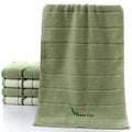 Pure cotton 32 strand embroidered face washing towel in green, 34x74cm, folded on a surface