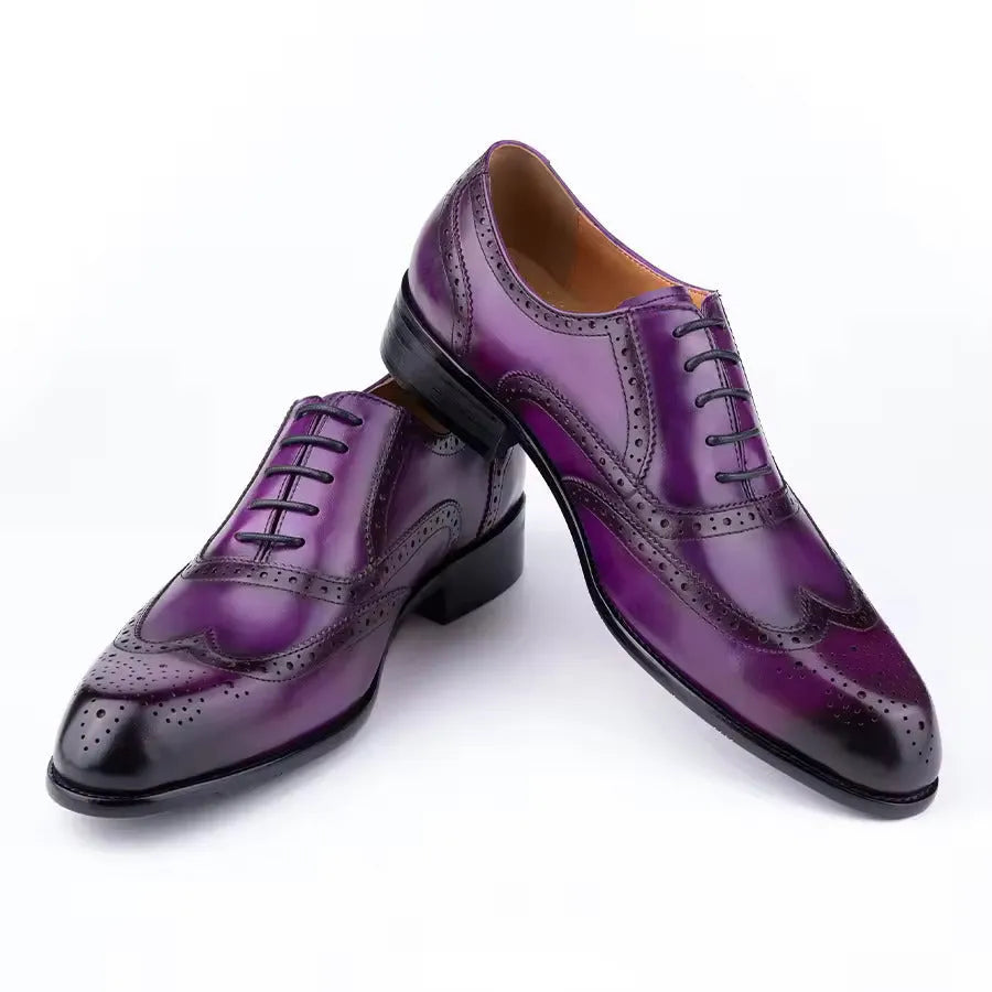 Men's purple leather Oxford dress shoes with hand-carved detail and pointed toe on a rubber sole.