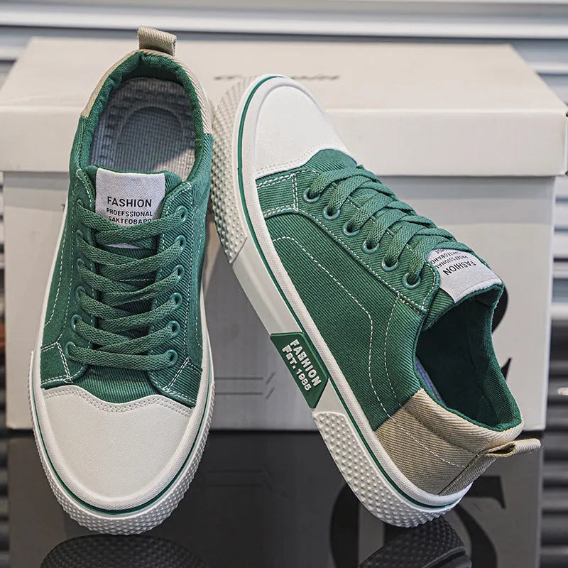 Men's blue low-top canvas casual sneakers with round toe and lace-up front on a white background.
