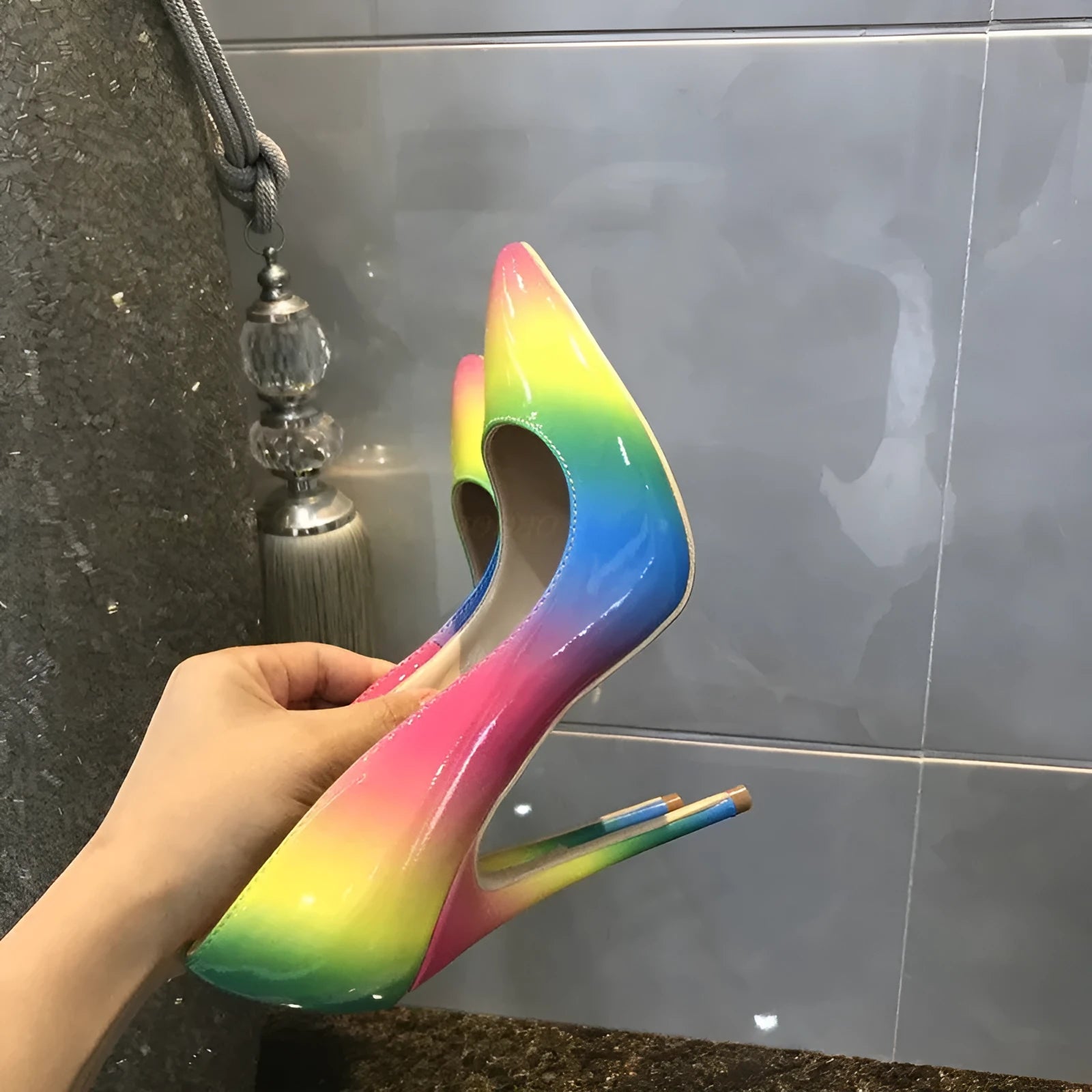 Rainbow patent leather women's high heel shoes with pointed toe and thin stiletto heel.