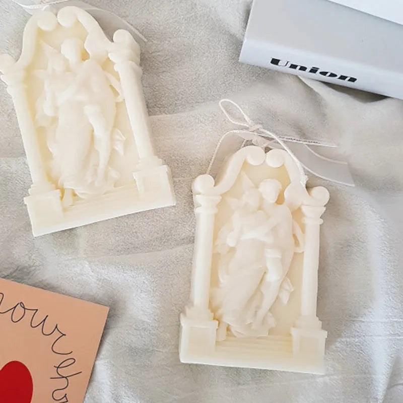 Square elf shaped silicone baking mold for angel aromatherapy candle ornaments and cake decorating on a plain background