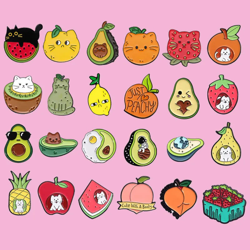 Colourful cartoon-style fruit metal brooch with pin clasp on a denim jacket lapel.