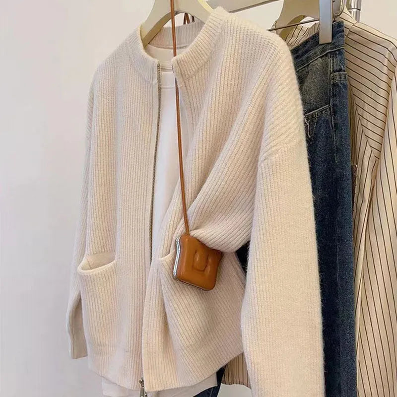 Beige viscose knit sweater coat cardigan with long sleeves laid flat.