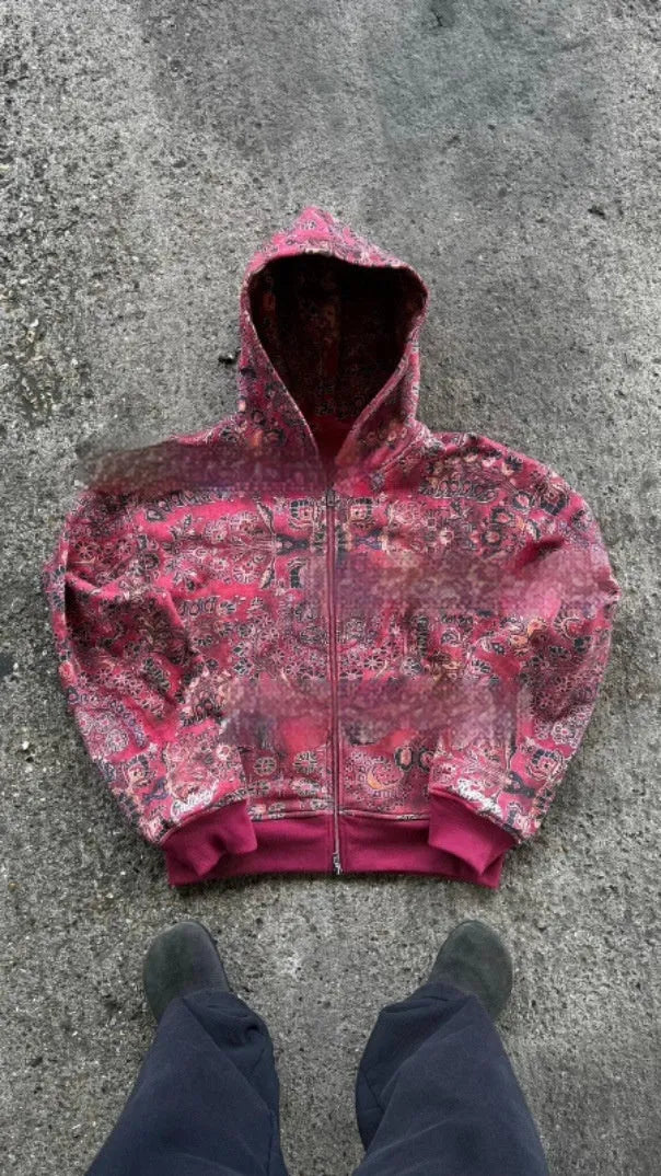 A red loose-fit men's hooded zip coat with long sleeves on a hanger.