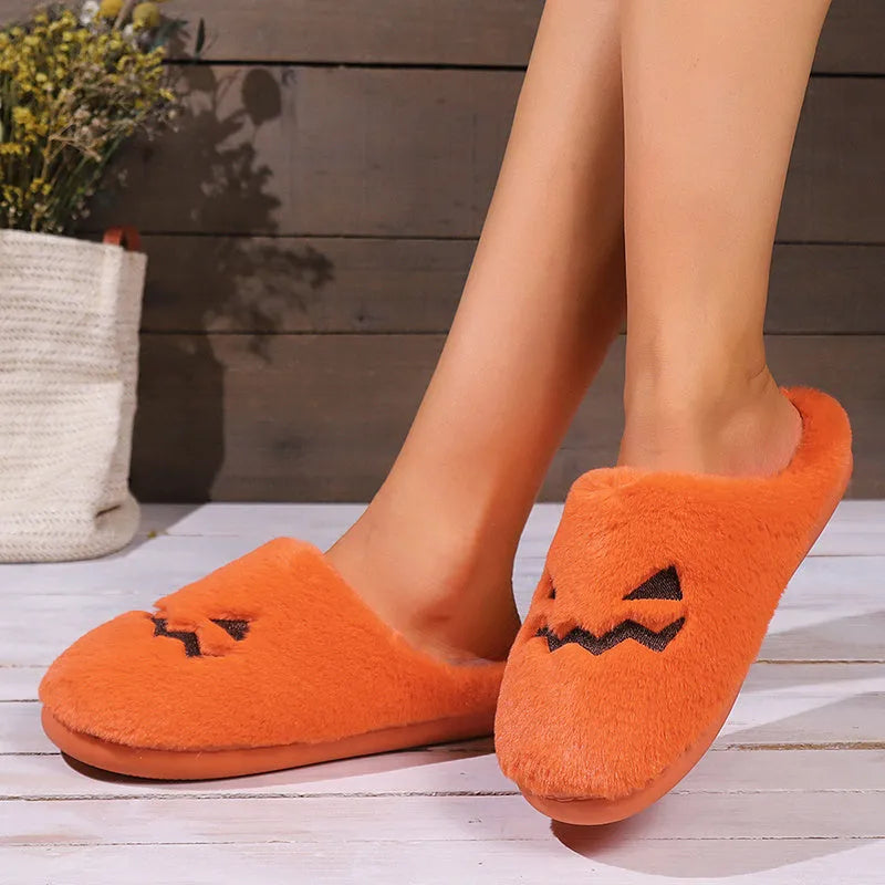 Orange coral velvet plush slippers with a non-slip PVC sole and fluffy lining.
