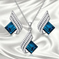 Silver-tone cross chain necklace and matching earring set with glass pendant details