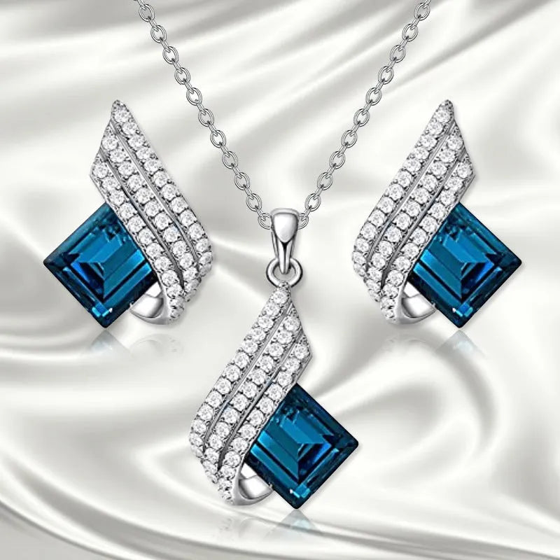 Silver-tone cross chain necklace and matching earring set with glass pendant details