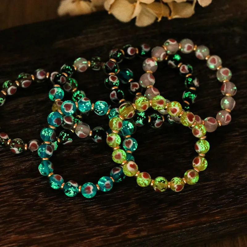 Handmade glass bracelet with swallowing gold beast charm and heart-shaped fluorescent glaze beads