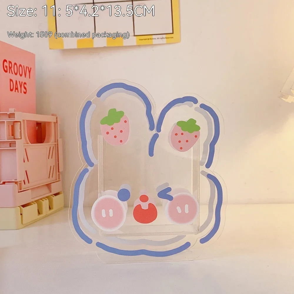 Square transparent acrylic storage box with a cute decorative design, shown on a desk.