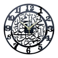 Acrylic black wall clock 30cm Mediterranean style with gold accents hanging on a light-coloured wall