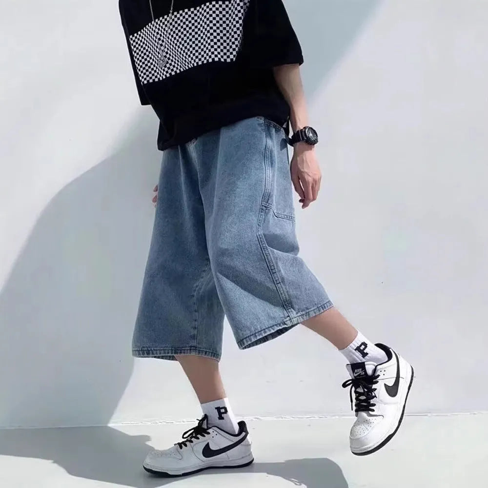 Blue washed denim men's shorts with a high waist and cropped, straight-leg pirate style.
