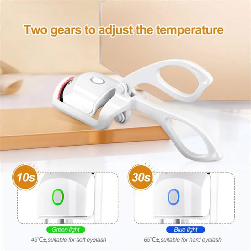 White and pink USB rechargeable heated eyelash curler with temperature control settings.