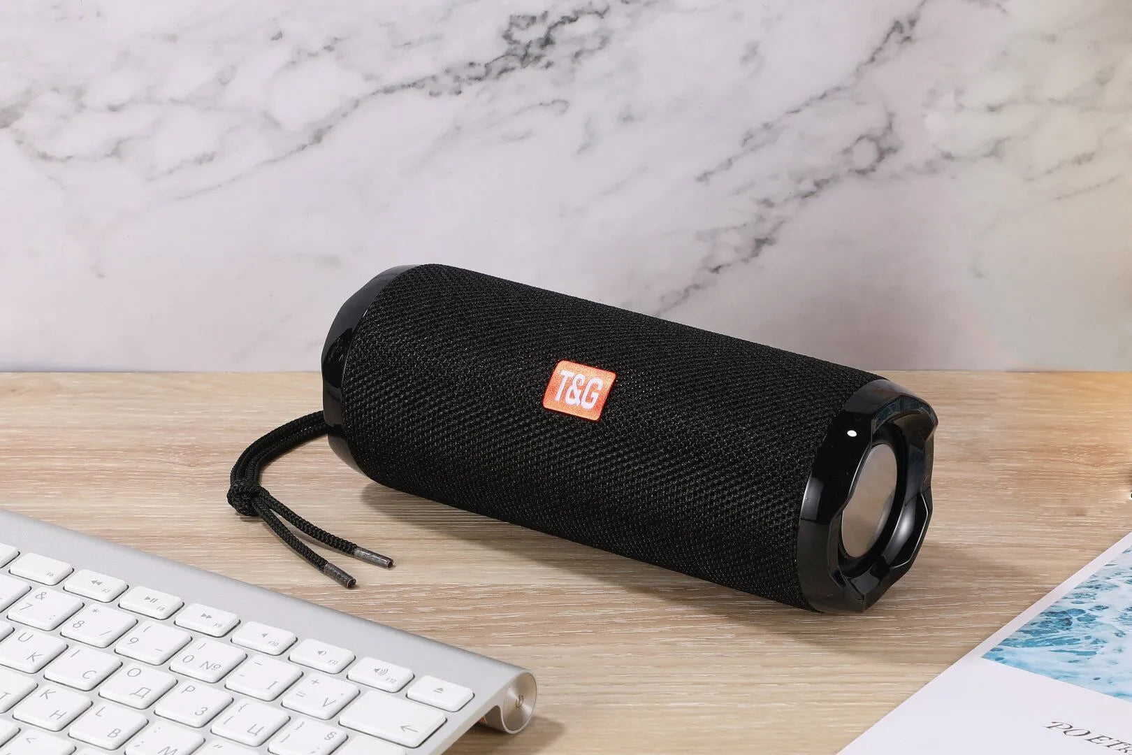Fabric-covered portable Bluetooth speaker with integrated card holder in multiple colour options.