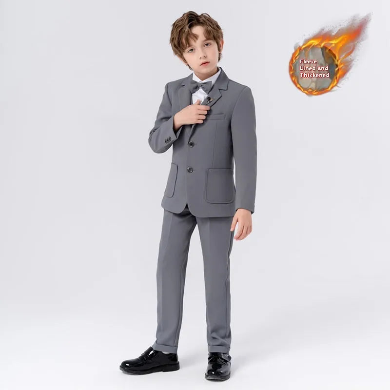 Boy's solid colour British style suit dress set with coat, trousers, vest, bow tie, and brooch on a hanger