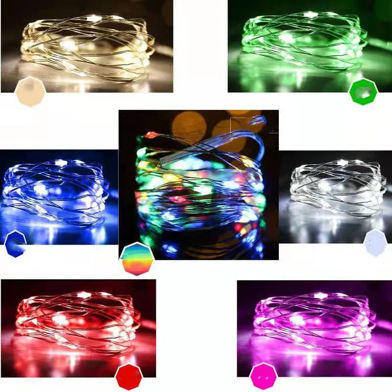 Copper wire fairy lights wrapped around a jar, showing warm white LEDs and a small battery box on a wooden table.