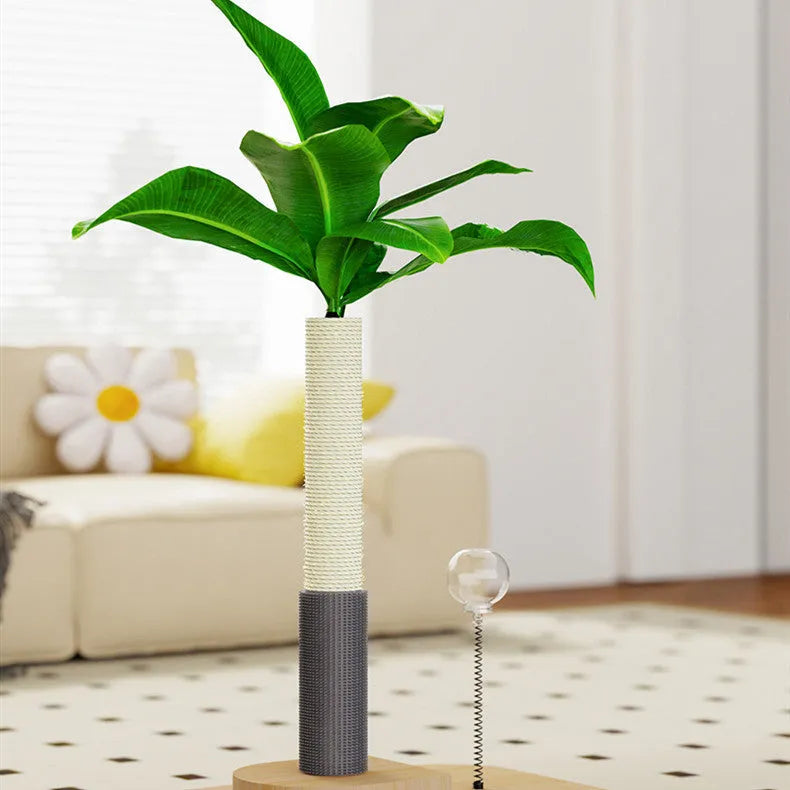 Natural canna coloured wooden cat scratching post with sisal rope and a dangling white ball toy on a grey carpet