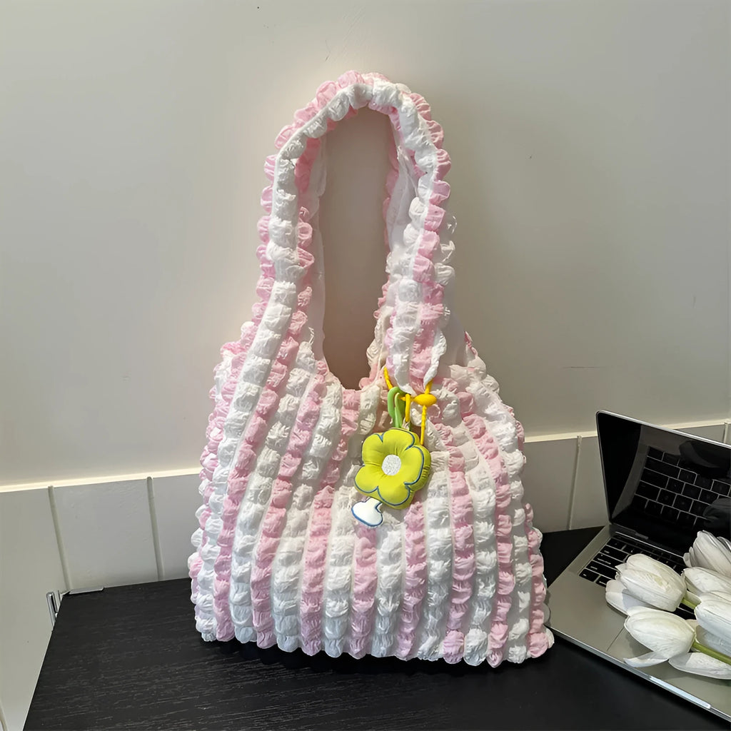 Women's pleated bubble shoulder bag with a floral pendant in soft polyester, shown in a vertical square shape.