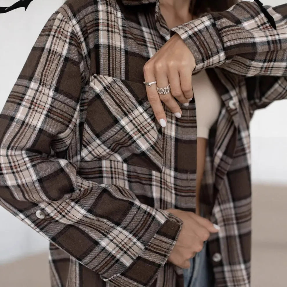 Dark brown striped long sleeve women's shirt with retro style collar on a hanger.