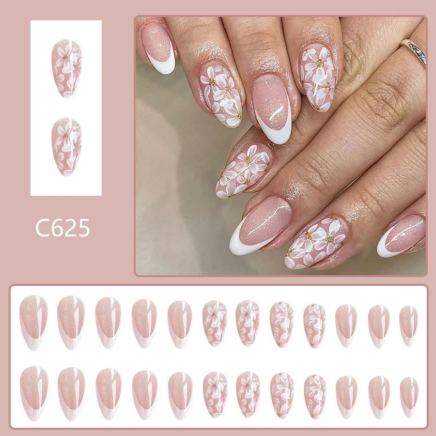 Short almond shaped false nails with glossy finish, glitter, and powder flower design in C625 colour.