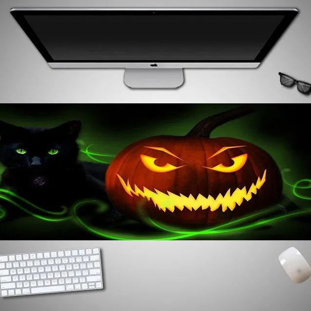 Large Halloween-themed rubber cloth mouse pad on a desk, showing non-slip backing and graphic design.
