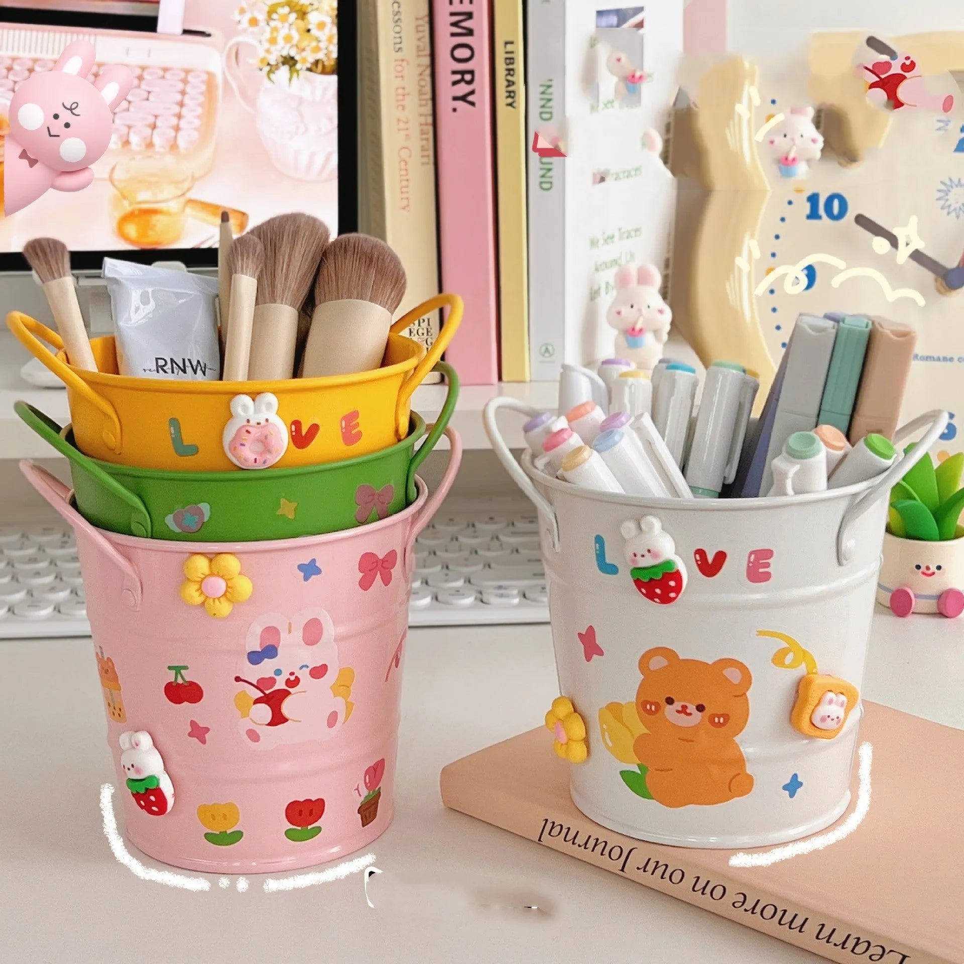 A round metal pen holder in various colours on a desk, holding pens and pencils.