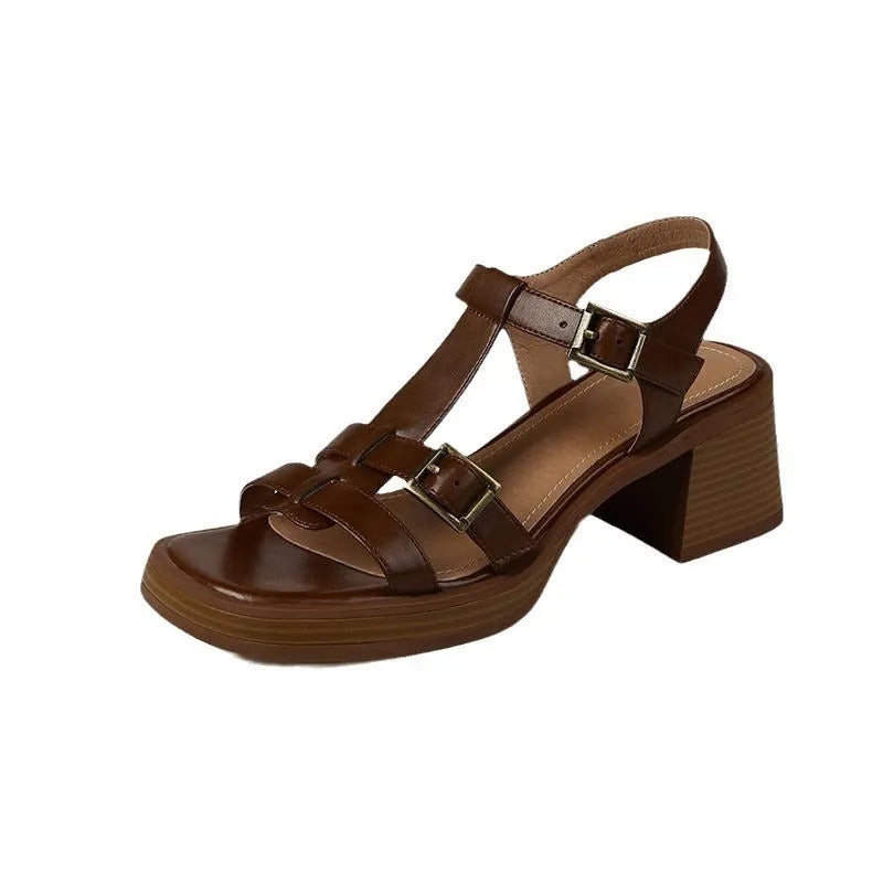 Women's black retro sandals with a chunky heel, platform, and T-shaped buckle fastening.