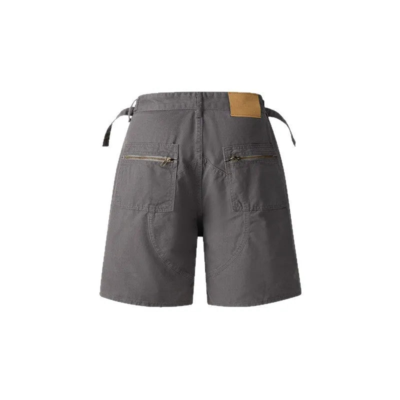 Retro loose-fit workwear shorts for men and women in washed cotton with a zipper fly, shown in grey colour.