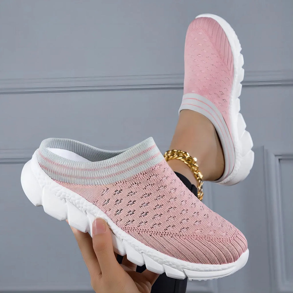 Women's black Flyknit semi-slipper casual shoe with striped pattern and hollow-out design on a white background.